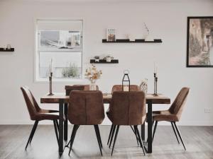 a dining room with a table and chairs at Modern holiday home in Hobart - Stunning Mountain & Water views in Rosetta