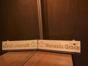 a sign for a harlemnsics garage on a wooden floor at Zenith Apartments Thamel - Manaslu 1BHK Apartment in Kathmandu