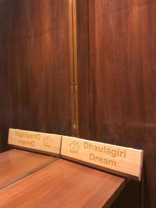 a sign for a wheelchair dream sitting on a wooden table at Zenith Apartments Thamel-Dhaulagiri 1BHK Apartment in Kathmandu