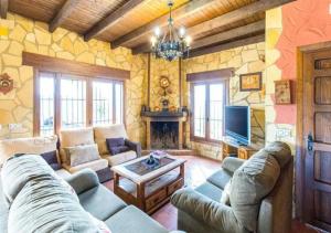 a living room with a couch and a tv at Villa 10 by Villamya in El Gastor