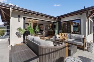 a patio with two couches and a table at Ocean Whispers home in Moss Beach