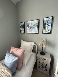 a bedroom with a couch and four pictures on the wall at Maison Claire in Chester +55 photos