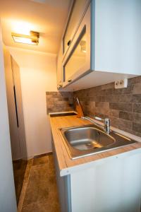 a kitchen with a sink and a counter top at Barrique Brâncoveanu 3 in Braşov