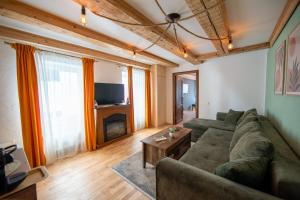 a living room with a couch and a table at Barrique Brâncoveanu 3 in Braşov