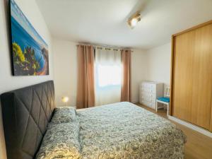 a bedroom with a bed and a large window at Mansa Beach I - Vv Playa San Juan in Guía de Isora