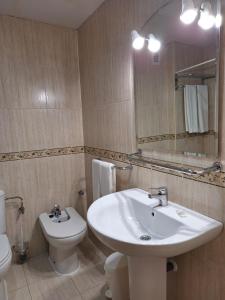 a bathroom with a sink and a toilet and a mirror at Cazorla LIVE in Cazorla +75 photos