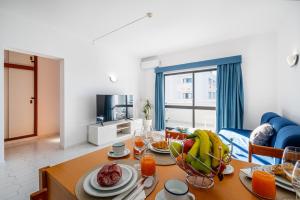 a living room with a table with fruit on it at Cozy Apartment with indoor pool in Albufeira