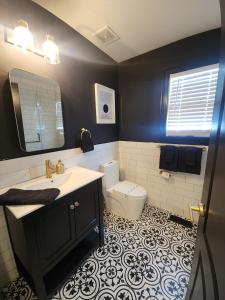 a bathroom with a sink and a toilet in it at Chic Haven- Close to Beach, Boardwalk & Casinos in Atlantic City +42 photos