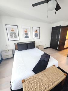 a bedroom with a large white bed and pictures on the wall at Chic Haven- Close to Beach, Boardwalk & Casinos in Atlantic City