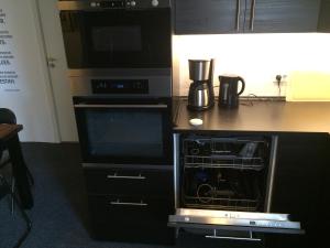 a kitchen with an oven and a microwave at Amazing Herlev in Herlev