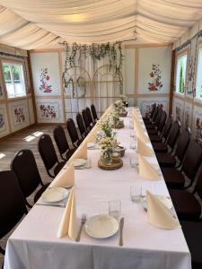 a long table in a room with chairs at Noclegi I Restauracja Zodiak in Gliwice