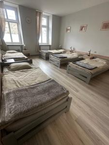 a room with four beds in a room at Noclegi Społem in Będzin