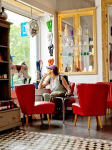 a man sitting at a table in a room at Káli Cool in Káptalantóti