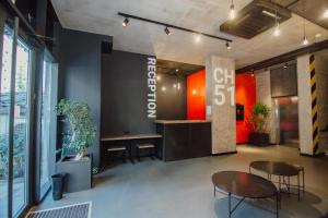 a lobby with two tables and a sign that says gift shop at Hotel CH51 in Batumi +27 photos