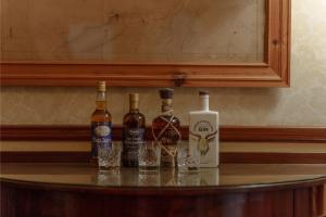 a group of bottles of wine sitting on a table at Sherramore Lodge in Laggan