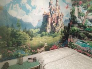 a bedroom with a castle mural on the wall at Camino Bed and Breakfast Corme in Corme-Puerto