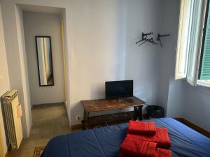 a bedroom with a bed and a desk with a computer at Ostiense 6 in Rome
