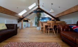 a living room with a couch and a table at Edale - Loft with a view in Edale