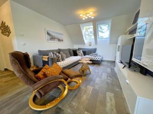a living room with a couch and a tv at Ferienwohnung Litus in Binz +16 photos