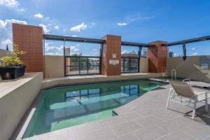 a swimming pool on the roof of a building at 1Bed 1Bath with Story Bridge and River Views, Parking, and Private Balcony M7 in Brisbane