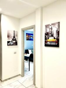 a living room with two pictures on the wall at Luxury B&B home near Turin center in Turin
