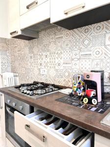 a kitchen with a stove and a counter top at Luxury B&B home near Turin center in Turin
