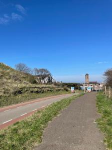 an empty road next to a house on a hill at Beachhouse Wijk aan Zee! in Wijk aan Zee +5 photos