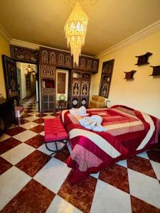a bedroom with a bed and a checkered floor at Ventana al mar , Tánger in Tangier