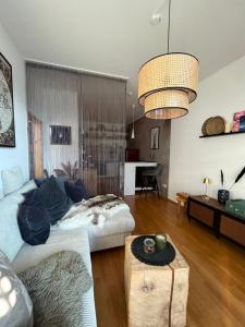 a living room with a couch and a table at AllgäuLoft im Sennhof in Weiler-Simmerberg +25 photos