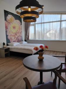 a living room with a bed and a table with a table sidx sidx at Blom studio's in Hillegom