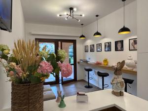 a living room with a vase of flowers on a table at Domo Grace in Porto San Paolo