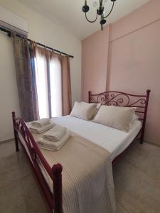 a bedroom with a bed and a window at Aeon Blue in Sikinos