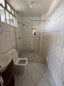 a bathroom with a toilet and a sink at Cosy 2 bedroom apartment in Arusha