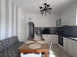 a kitchen with a table and a dining room at Aeon Blue in Sikinos
