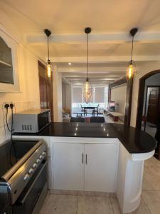 a kitchen with a black counter top in a room at Cosy 2 bedroom apartment in Arusha