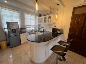 a kitchen with a large island in the middle at Cosy 2 bedroom apartment in Arusha +2 photos