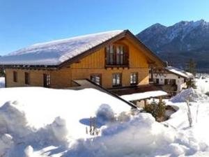 a house with snow in front of it at Haus Berglust Wallgau in Wallgau