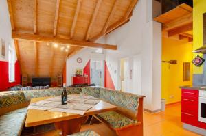 a living room with a couch and a table with a bottle of wine at Ferienwohnung Saupp in Immenstaad am Bodensee