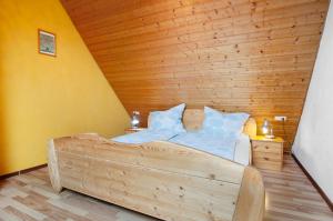 a bedroom with a large bed with a wooden ceiling at Ferienwohnung Saupp in Immenstaad am Bodensee +17 photos