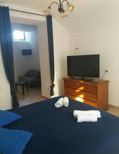 una camera con letto, TV e asciugamani di A Sorrento B&B,relaxing location with Seaview a Sorrento