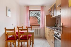 a kitchen with a table and chairs in a kitchen at Grözinger in Utzstetten