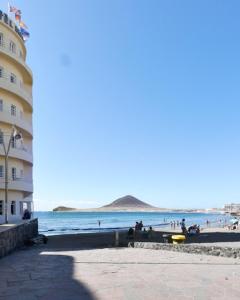 a group of people on the beach near a building at Casa Sole in El Médano