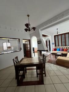 a living room with a table and a couch at Blue pearl Mogador in Essaouira