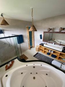 a large white bath tub in a room at Brisa Atlantica in Barra de São Miguel
