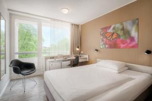 Postel nebo postele na pokoji v ubytování PARKHOTEL Hameln - ehemals Mercure Hotel Hameln