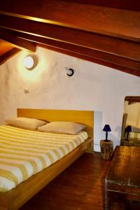 Un dormitorio con una cama con cabecero de madera. en La Baita di Vararo - Relax&Natura, en Cittiglio