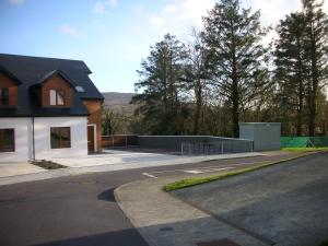 a house with a parking lot next to a street at 18 Carraig Naofa in Bantry