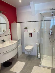 a bathroom with a toilet and a sink and a shower at Maison Gille in Nuits-Saint-Georges