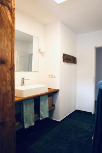 a bathroom with a sink and a mirror at Ferienwohnung Sepp in Inzell