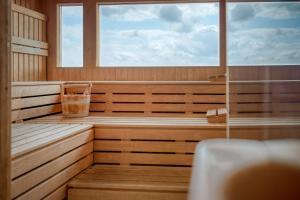 a sauna with a window and a empty tub at PARKHOTEL Hameln in Hameln